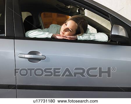 Girl (12-14) sitting in car, leaning on open window View Large Photo Image Stock Image - Girl (12-14) sitting in car, leaning on open window. Fotosearch