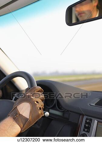 Gloved hand on steering wheel View Large Photo Image Stock Image - Gloved hand on steering wheel. Fotosearch