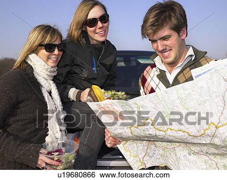 Group looking at map at rest stop View Large Photo Image Stock Photograph - Group looking at map at rest stop. Fotosearch