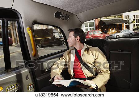 Picture - Man looking out of taxi window. Fotosearch