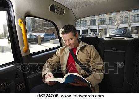Stock Photo - Man reading in London Taxi . Fotosearch