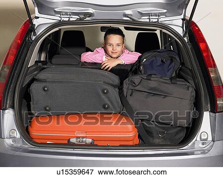 Young girl (5-7) sitting in backseat of car, smiling, portrait View Large Photo Image Stock Photo - Young girl (5-7) sitting in backseat of car, smiling, portrait. Fotosearch