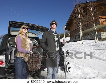 Young man and woman in front of car View Large Photo Image Stock Photo - Young man and woman in front of car. Fotosearch