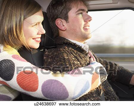 Stock Photo - Young woman hugging driver. Fotosearch
