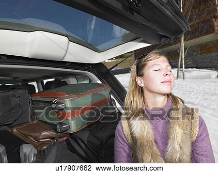 Young woman in front of packed car View Large Photo Image Stock Image - Young woman in front of packed car. Fotosearch