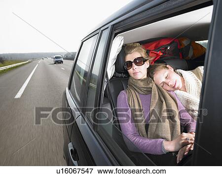 Stock Photo - Young women sleeping in car. Fotosearch