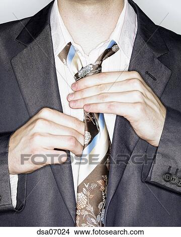 Businessman straightening tie Picture | dsa07024 | Fotosearch