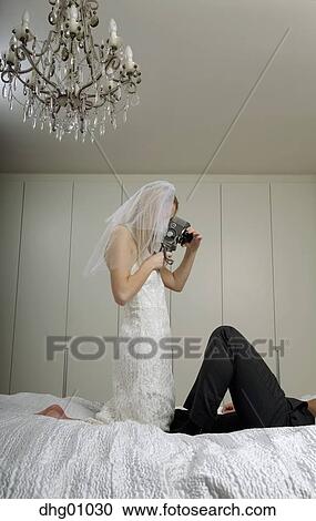 https://fscomps.fotosearch.com/compc/UPC/UPC002/young-bride-and-groom-filming-their-stock-image__dhg01030.jpg
