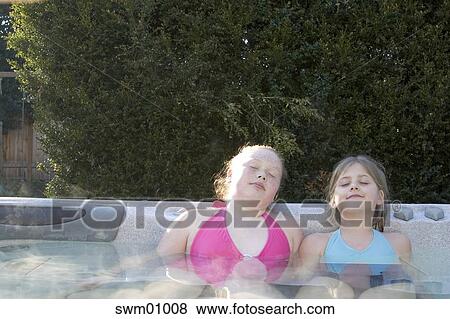 Young Girls Relaxing In Hot Tub Stock Photo