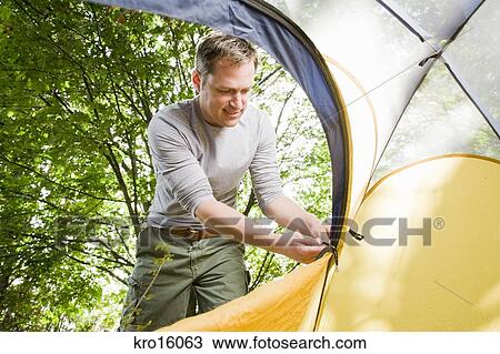 Man zipping up tent Stock Image | kro16063 | Fotosearch