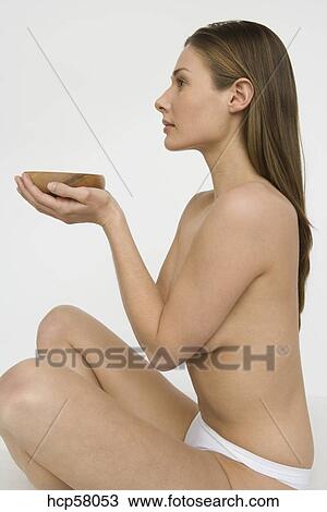 Young nude woman holding a bowl Stock Image | hcp58053 ...