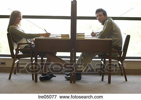 Woman Rubbing Man S Leg Under The Table Stock Photo Tre05077 Stock Photo Woman Rubbing Man S Leg Under The Table Fotosearch