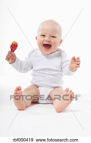 baby holding rattle