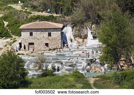 Italy Tuscany Province Of Grosseto Saturnia View Of People At Thermal Waterfalls And Travertine Pool Stock Image - 