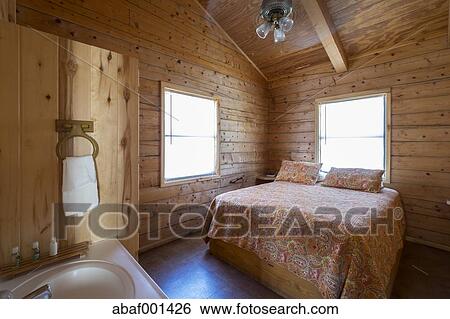 Usa Texas Bedroom With Bathroom Vanity In Log Home Stock