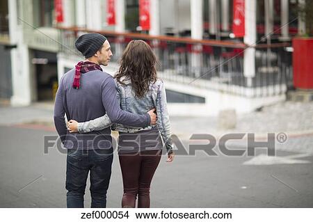 Young Couple Walking Arm In Arm On The Street Picture Zef Fotosearch