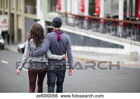 Young Couple Walking Arm In Arm On The Street Stock Photograph Zef Fotosearch