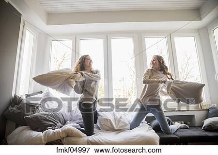 Pillow Fight Between Two Best Friends At Home Stock Photo