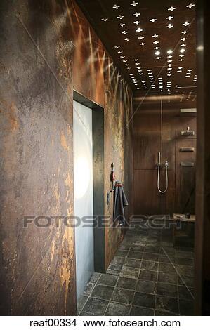 Modern Bathroom With Corten Steel Wall Cladding And Ceiling Light