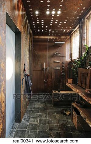 Modern Bathroom With Corten Steel Wall Cladding And Ceiling Light