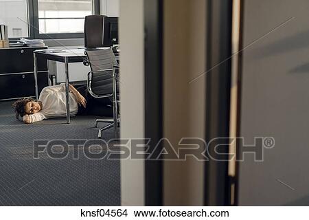 Tired Businesswoman Sleeping On Floor Under Her Desk Picture