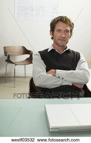 Young Man Sitting On Desk Arms Crossed Stock Image Westf03532