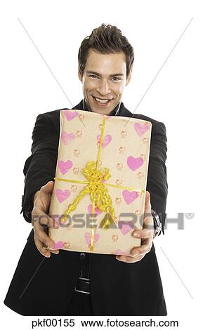 Stock Image Of Young Man Holding Present Close Up Pkf00155 Search Young Man Holding Present Close Up