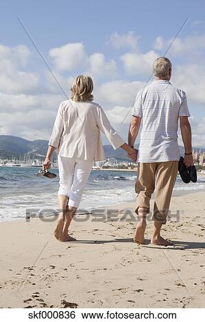 Stock Images Of Spain Mallorca Senior Walking Along Beach Spain Mallorca Senior Walking Along Beach