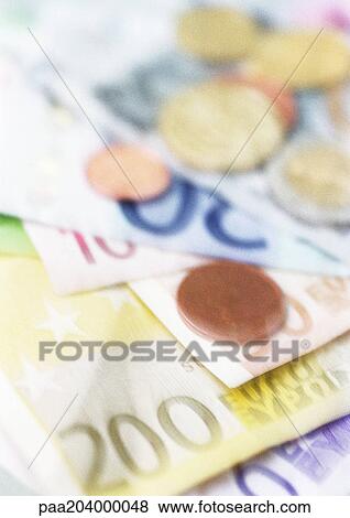 Pile of euro notes and coins, close-up View Large Photo Image Stock Photo - Pile of euro notes and coins, close-up. Fotosearch