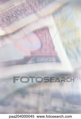 Stock Photography - Stack of paper currency, close-up. Fotosearch
