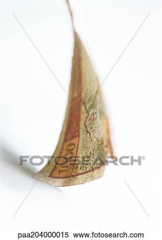 Stock Photography - Torn banknote, close-up. Fotosearch