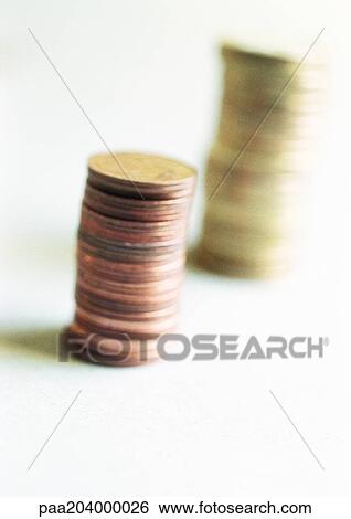 Stock Photograph - Two piles of euro coins, close-up. Fotosearch