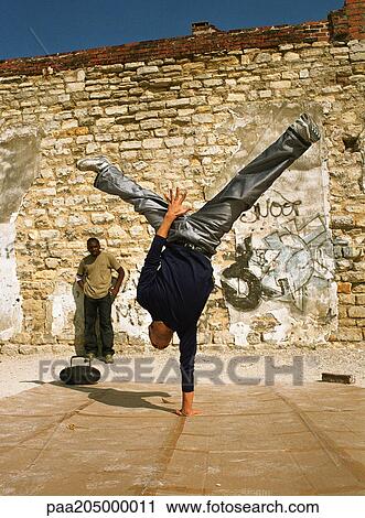 Man balancing on one hand, break dancing View Large Photo Image Stock Image - Man balancing on one hand, break dancing. Fotosearch