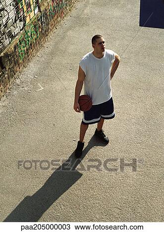 Man holding basketball, shot from above View Large Photo Image Stock Image - Man holding basketball, shot from above . Fotosearch