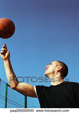 Man looking up at spinning basketball View Large Photo Image Stock Photography - Man looking up at spinning basketball. Fotosearch