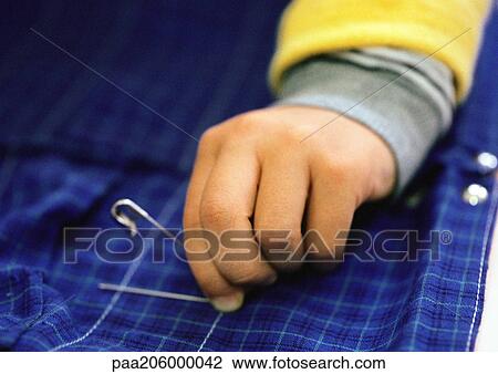 Child's hand holding safety pin, close-up View Large Photo Image Stock Image - Child's hand holding safety pin, close-up. Fotosearch