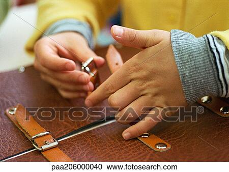 Childs hands fastening strap on satchel, close-up View Large Photo Image Stock Image - Childs hands fastening strap on satchel, close-up. Fotosearch