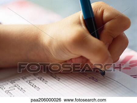 Hand holding ballpoint pen on notebook, close-up View Large Photo Image Stock Photograph - Hand holding ballpoint pen on notebook, close-up. Fotosearch