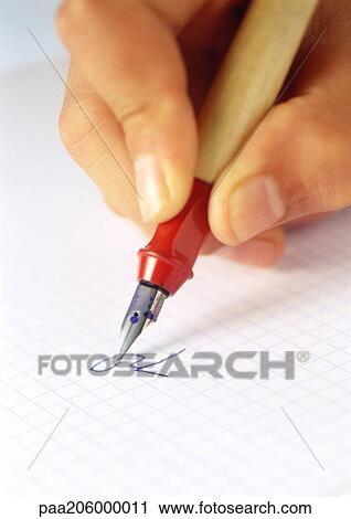 Stock Image - Hand using fountain pen, close-up. Fotosearch