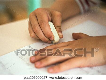 Hands holding eraser on notebook View Large Photo Image Stock Photo - Hands holding eraser on notebook. Fotosearch