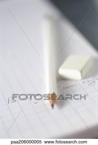 Stock Photography - Notebook, pencil and eraser, close-up. Fotosearch