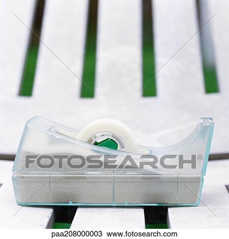 Adhesive tape dispenser on plastic lounge chair, close-up View Large Photo Image Stock Image - Adhesive tape dispenser on plastic lounge chair, close-up. Fotosearch