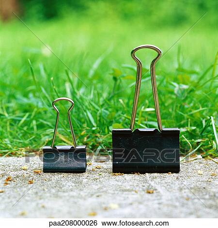 Binder clips on ground View Large Photo Image Stock Photograph - Binder clips on ground. Fotosearch