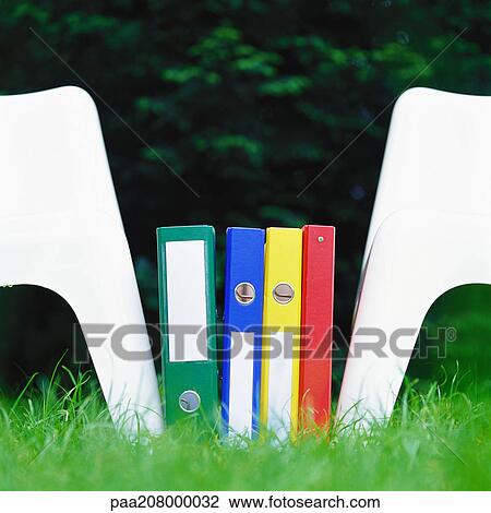 Files between two chairs on grass View Large Photo Image Stock Image - Files between two chairs on grass. Fotosearch