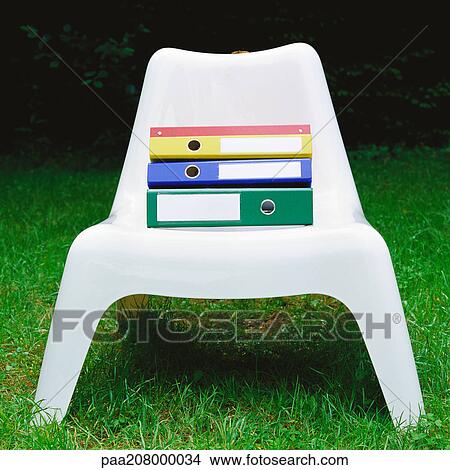 Files on plastic chair. View Large Photo Image Picture - Files on plastic chair.. Fotosearch