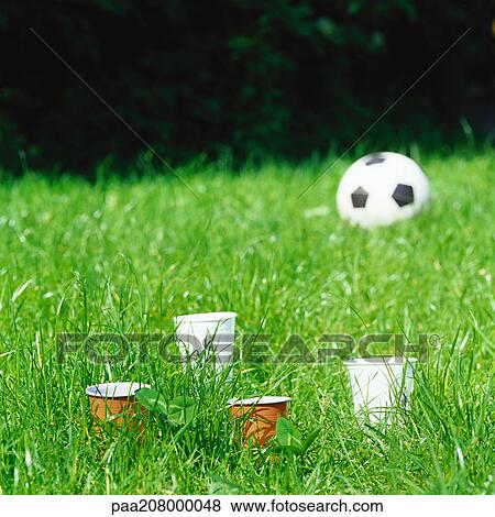 Paper cups and soccer ball in grass. View Large Photo Image Stock Photo - Paper cups and soccer ball in grass.. Fotosearch