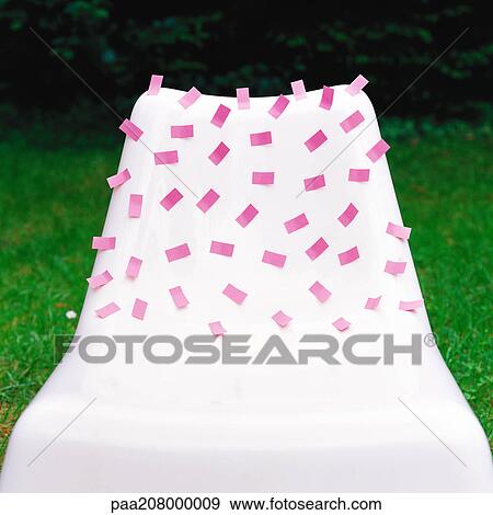 Pink adhesive notes stuck onto white plastic chair View Large Photo Image Stock Photo - Pink adhesive notes stuck onto white plastic chair. Fotosearch