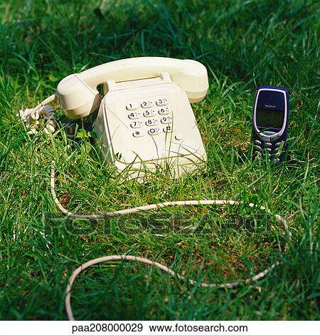 Telephone and cell phone in grass. View Large Photo Image Stock Photo - Telephone and cell phone in grass.. Fotosearch