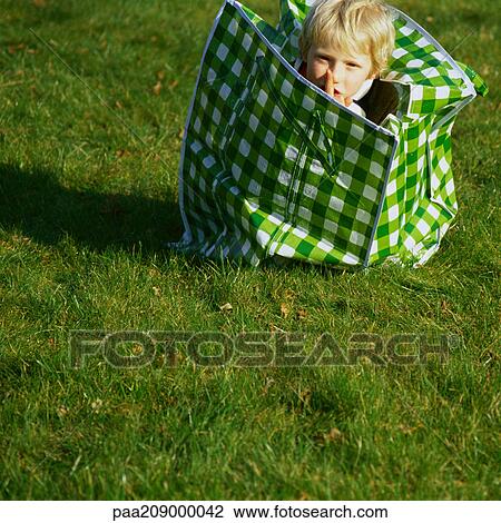 Child in laundry bag with finger over lips View Large Photo Image Stock Image - Child in laundry bag with finger over lips. Fotosearch