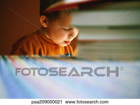 Child sitting at table, pile of books in foreground View Large Photo Image Stock Image - Child sitting at table, pile of books in foreground. Fotosearch